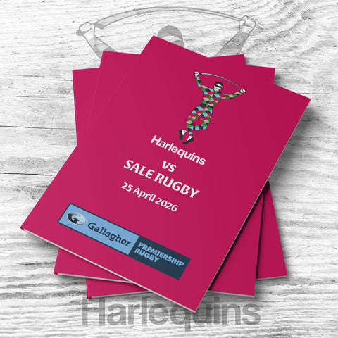 Stack of pink event programs for Harlequins vs Sale Rugby match on a wooden surface